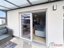 Wintergarten Lichtdurchflutetes Wohnen: KfW-55-Apartment mit Wintergarten, Aufzug und Doppelcarport!